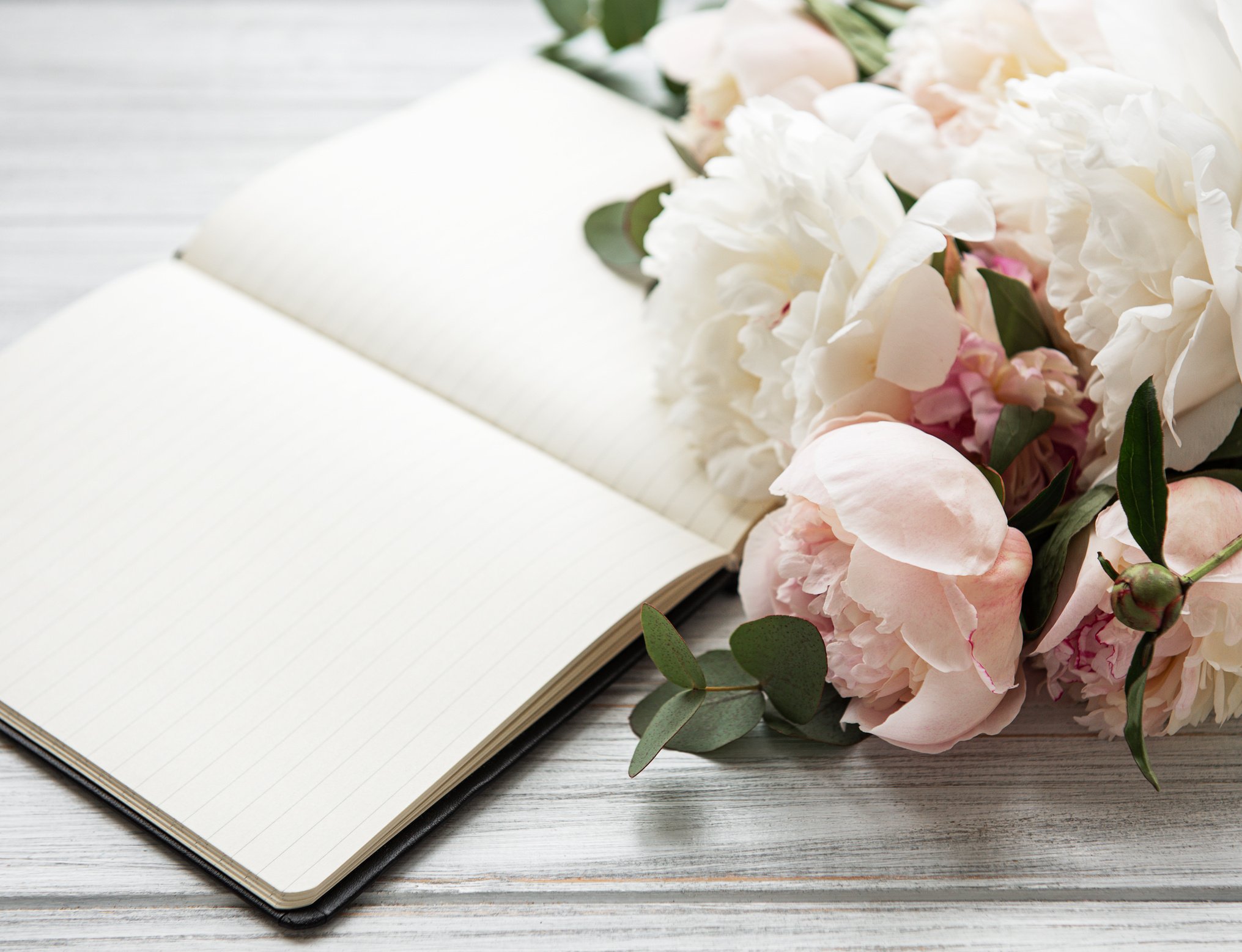 Peony Flowers Bouquet and Blank Notebook on Wooden Desk